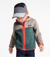 Child wearing colorblock quilted jacket with teal body, gray sleeves, and orange zip