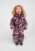 Child wearing a deep purple patterned one-piece winter overall with fur-trimmed hood, front view