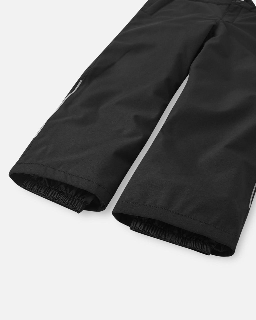 Black winter pants showing elastic cuffs at hem, close-up detail view
