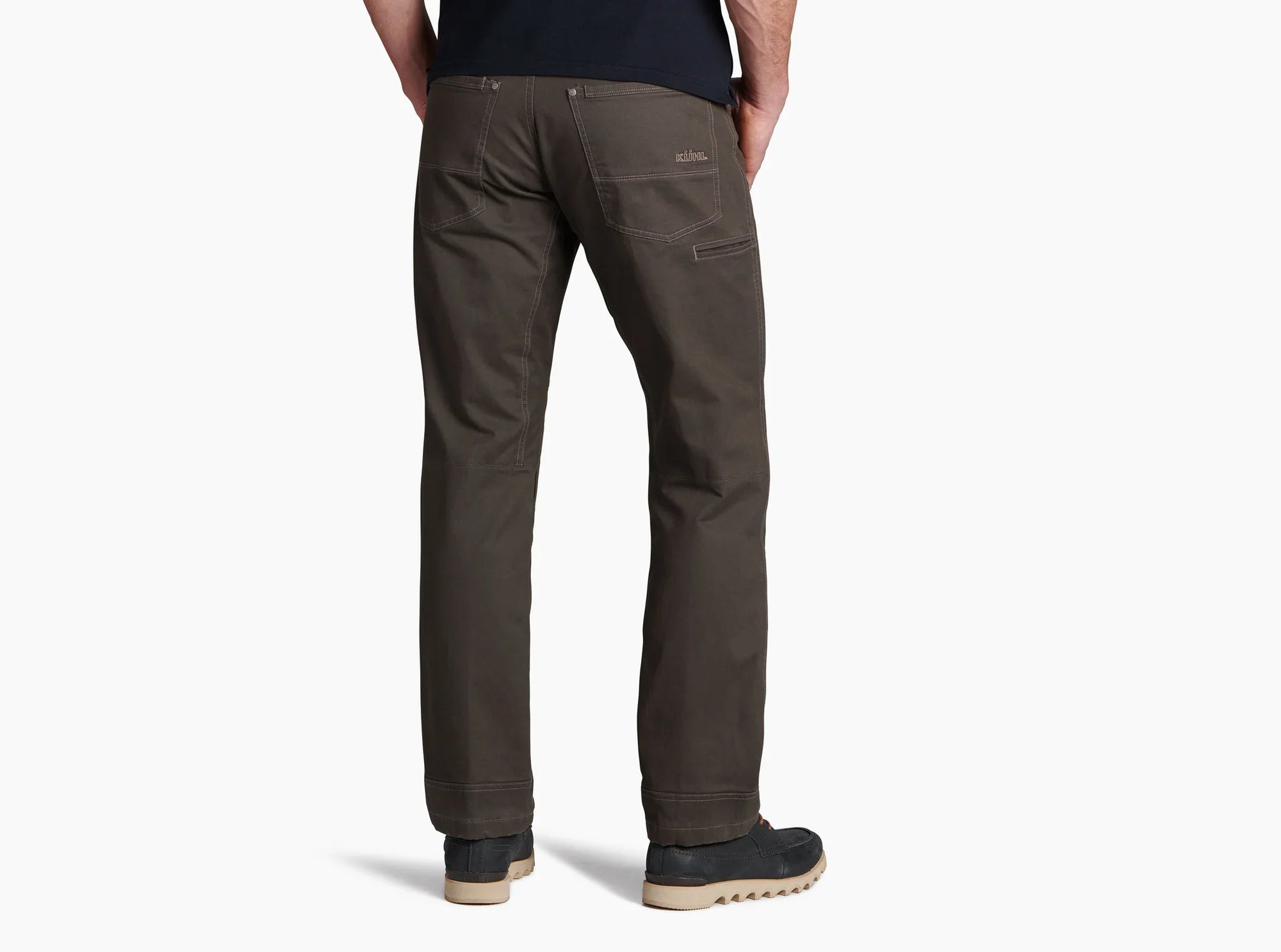 Men's work pants in dark olive brown, back view, with zip pocket and rugged boots