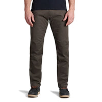 Men's slim-fit dark olive pants with articulated knees, front view on model with casual shoes