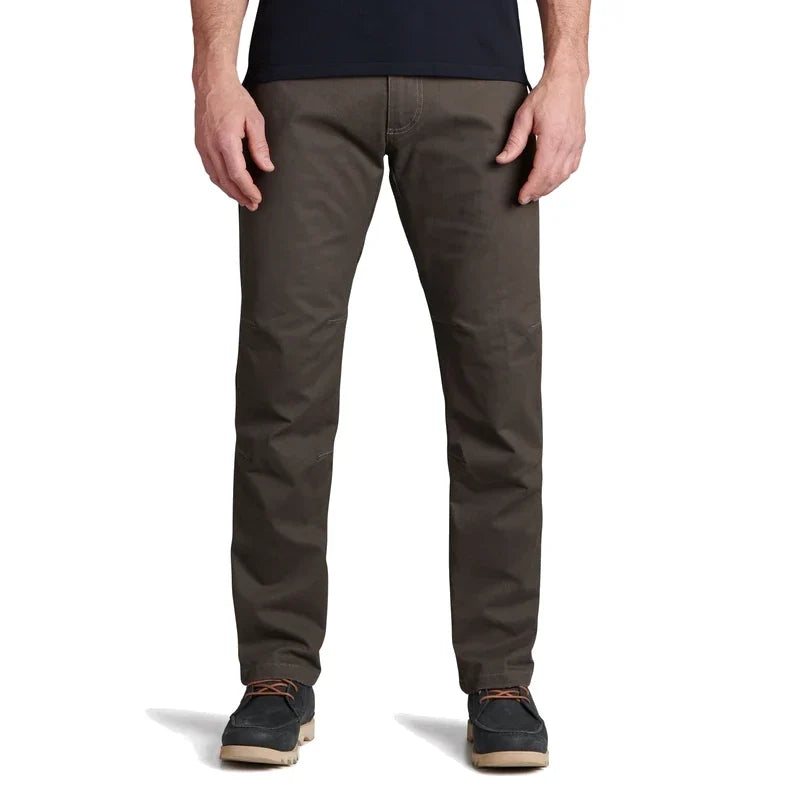 Men's slim-fit dark olive pants with articulated knees, front view on model with casual shoes