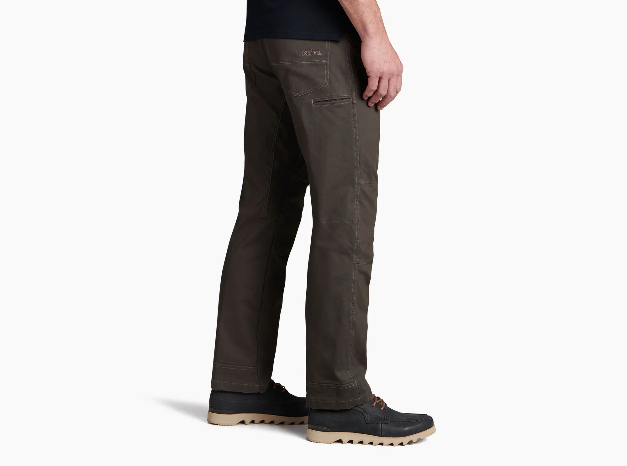 Men's dark olive work pants, right side view, worn with casual boat shoes