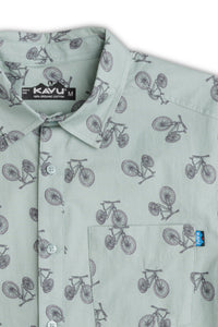 Light green button-up shirt with bicycle print pattern, collar and chest pocket detail