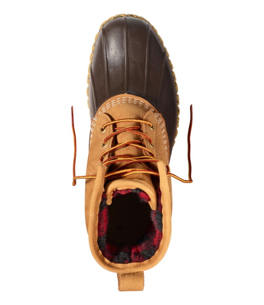 Top-down view of lace-up duck boot showing tan leather, brown rubber shell, and plaid fleece lining