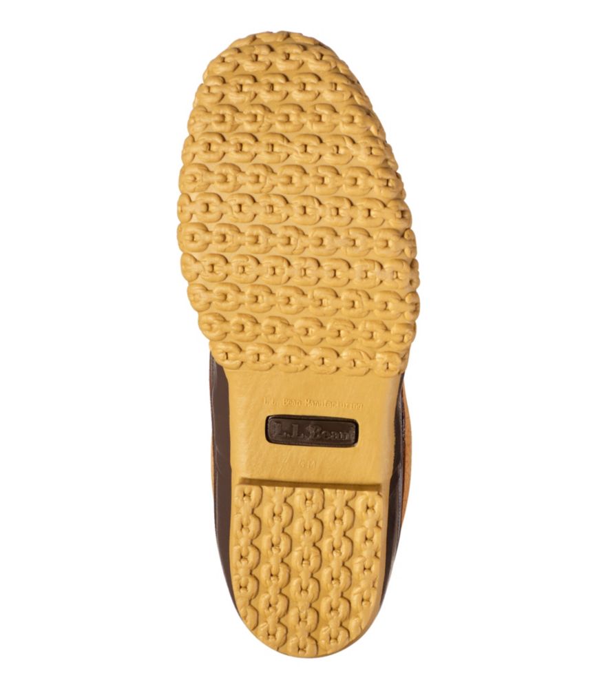 Bottom sole view of insulated boot showing textured gum rubber outsole with chain-link tread pattern