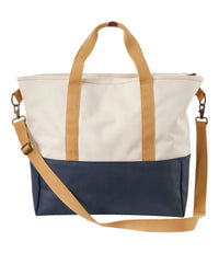Two-tone canvas tote bag with cream upper, navy lower section, and tan straps