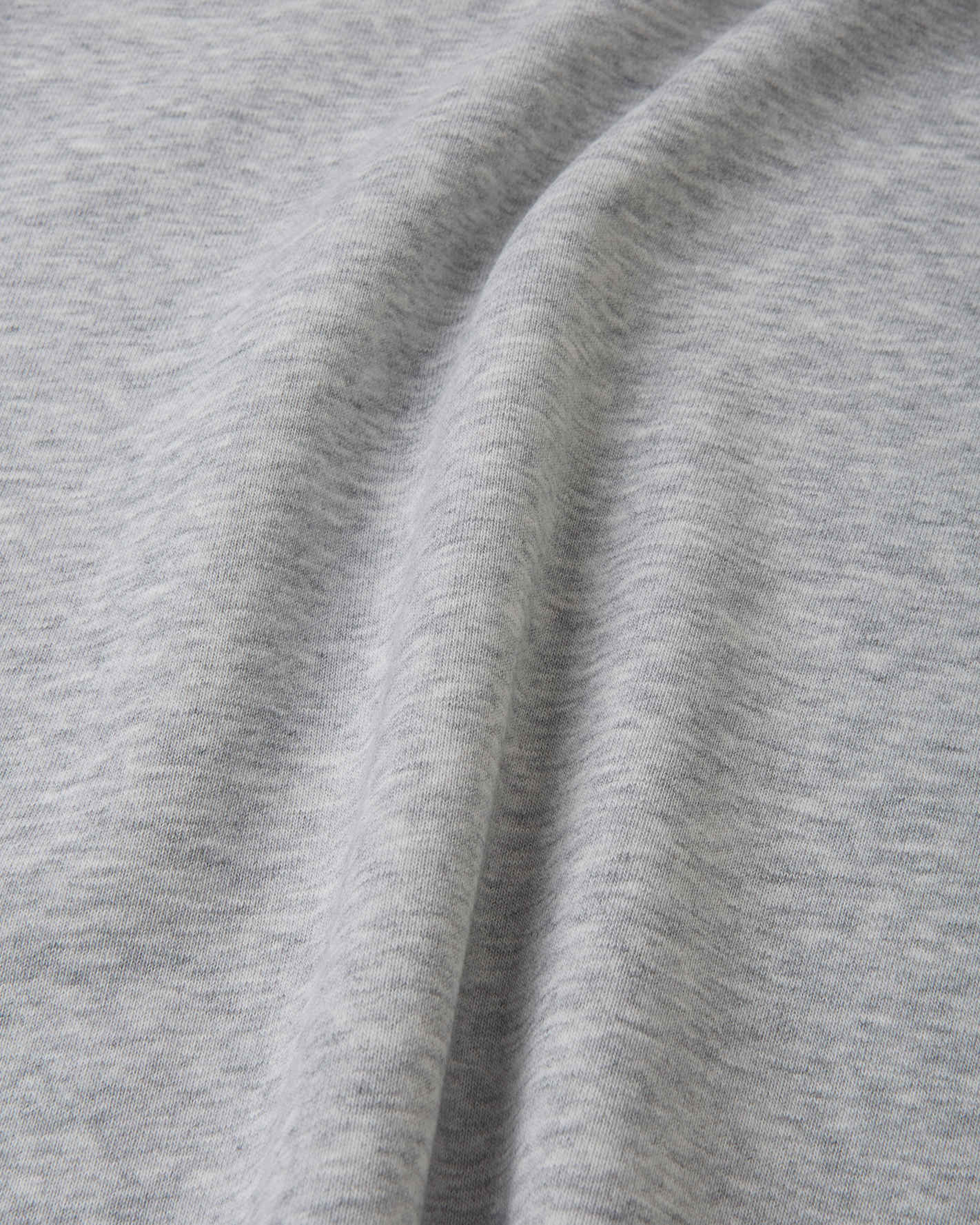 Light grey melange sweatshirt fabric close-up showing soft knit texture and seam detail