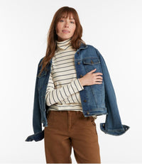 Woman wearing striped turtleneck with long sleeves and denim jacket, casual outfit styling