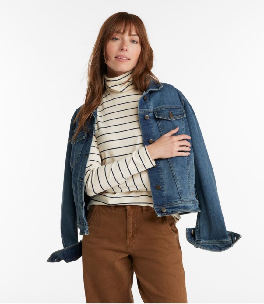 Woman wearing striped turtleneck with long sleeves and denim jacket, casual outfit styling