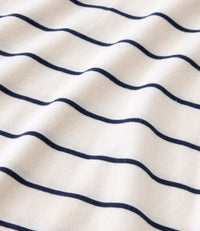 Striped knit fabric with navy horizontal lines on cream background, showing fabric texture and drape