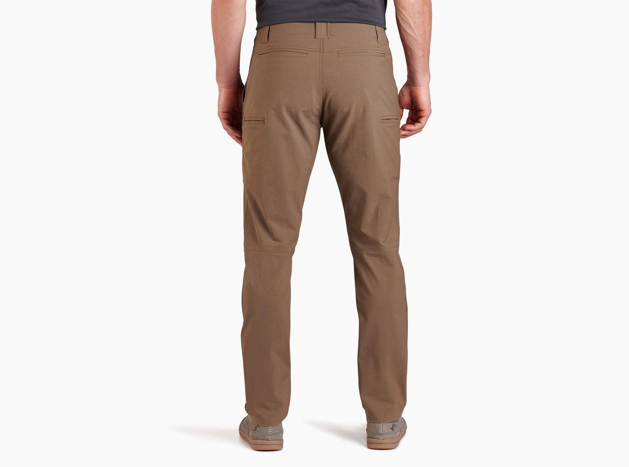 Men's chino pants in warm brown, back view showing rear pockets and tapered fit