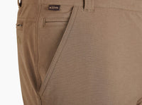 Close-up detail of men's chino pants showing front pocket, belt loop, and brand label