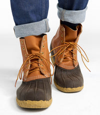 8-inch lace-up duck boots with tan leather upper, dark brown rubber toe box, worn with cuffed jeans
