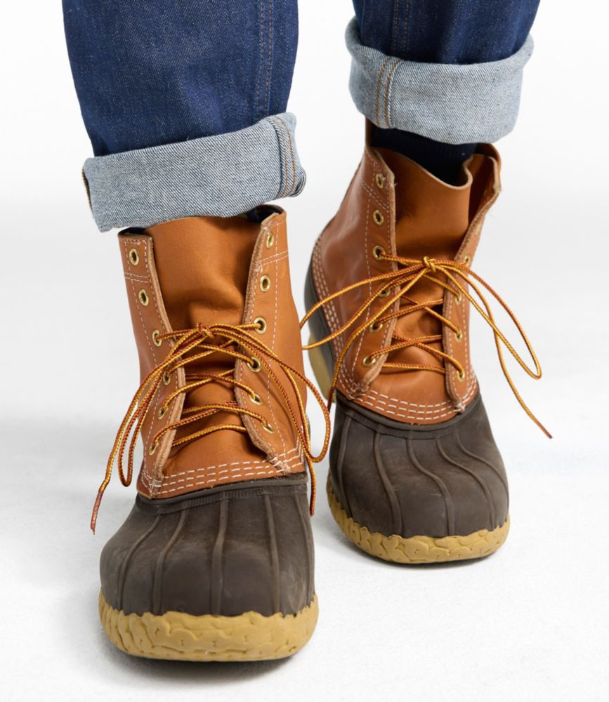8-inch lace-up duck boots with tan leather upper, dark brown rubber toe box, worn with cuffed jeans