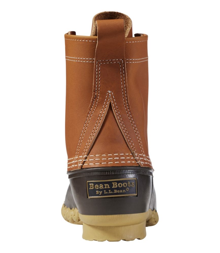 Duck boot rear view showing tan leather upper, dark brown rubber shell, and gum sole