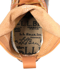 Close-up interior detail of duck boot showing branded insole, suede lining, and leather tongue