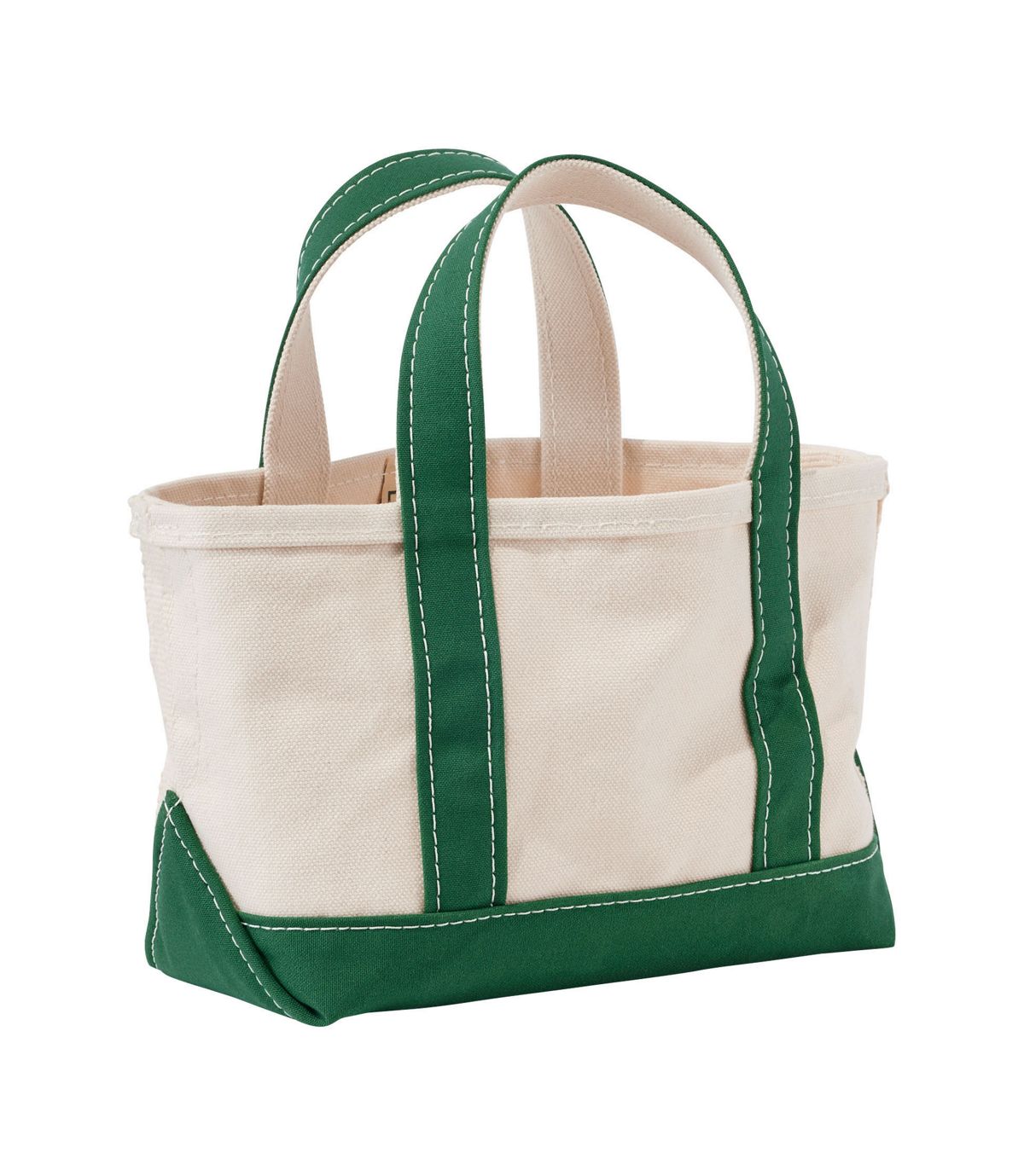 Small canvas tote bag with green handles, bottom trim, and natural cream body, angled view