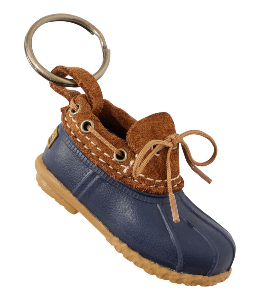 Miniature duck boot keychain with navy rubber sole and tan leather upper with laces