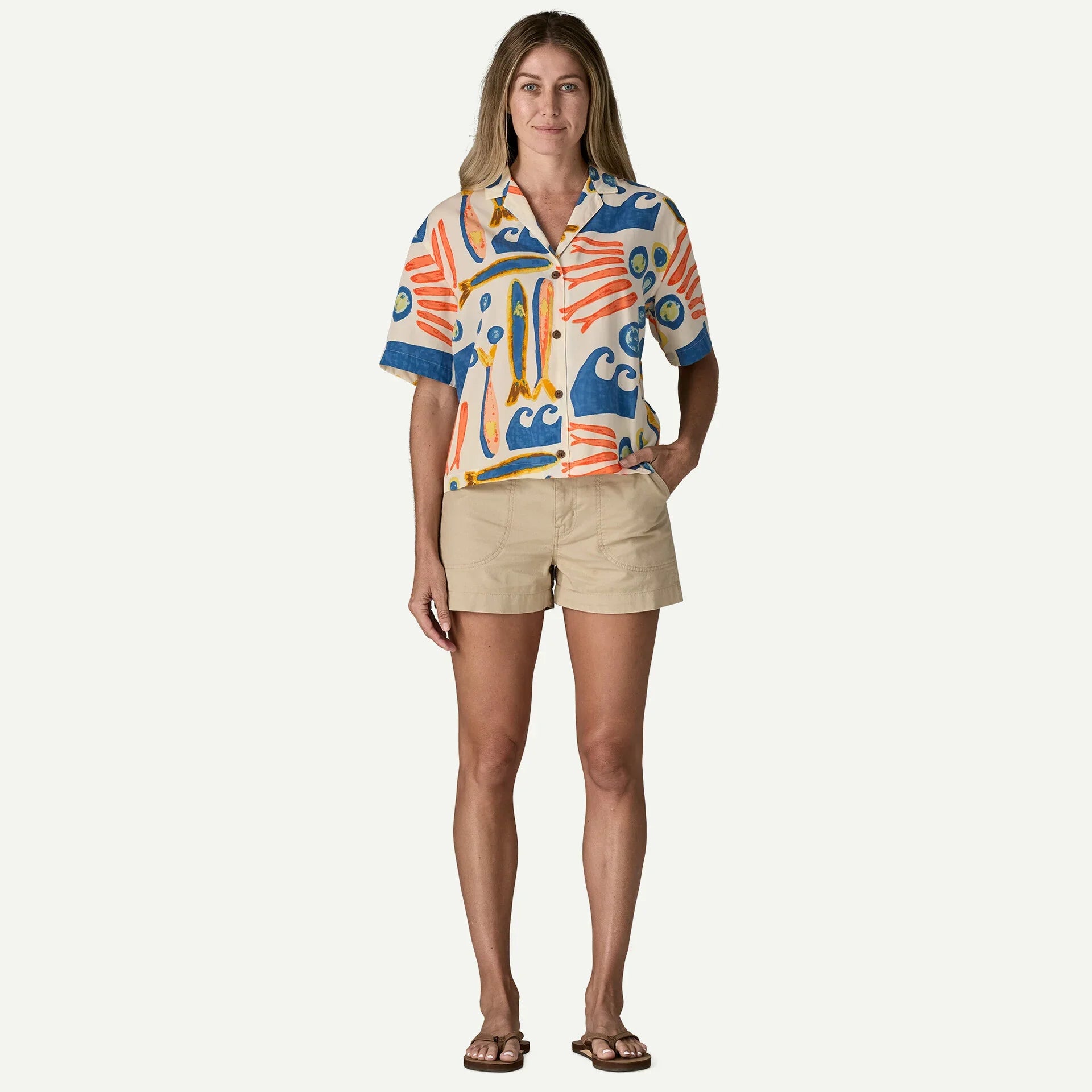 Short-sleeve button-up shirt with colorful abstract print, worn with khaki shorts