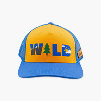 Yellow and blue trucker cap with WILD graphic featuring mountain, tree, and sun icons