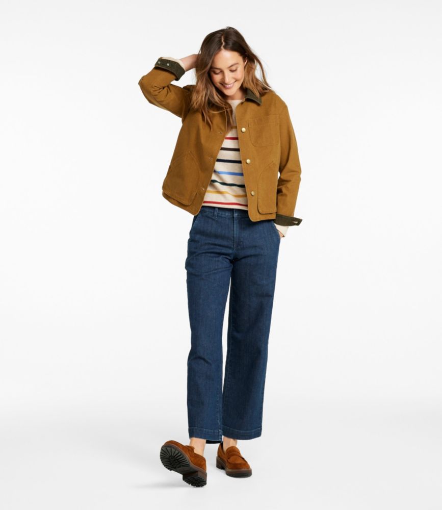 Brown corduroy field jacket with button closure worn over striped shirt and blue pants