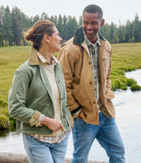 Woman wearing olive green lightweight field jacket with button front in outdoor setting