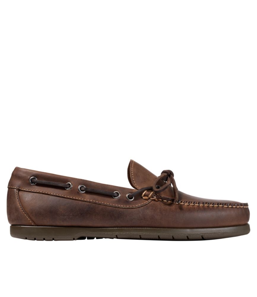 Brown leather moccasin loafer with lace detail and rubber sole, side view