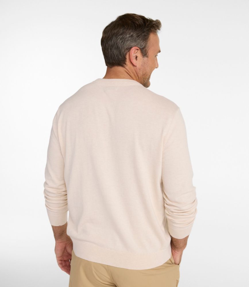 Men's crewneck sweater in light heather tone, back view on model with khaki pants