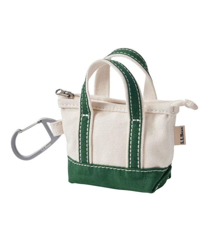 Miniature canvas tote bag with green trim and handles, zipper top, and carabiner clip
