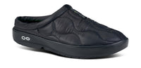 Black quilted slip-on mule with cushioned footbed and thick supportive sole, angled view