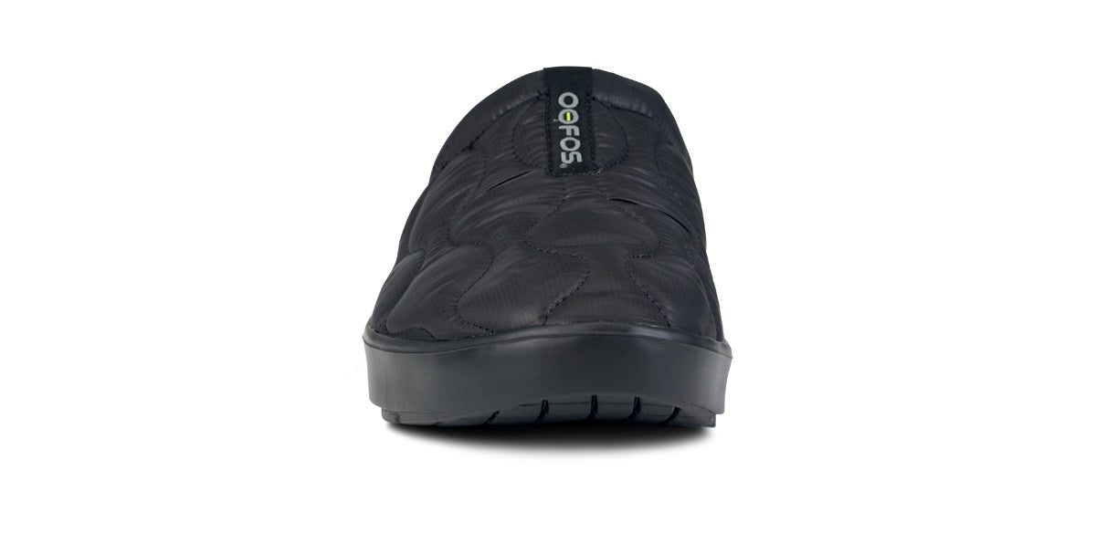 Black quilted slip-on mule shoe with textured upper and cushioned sole, front view
