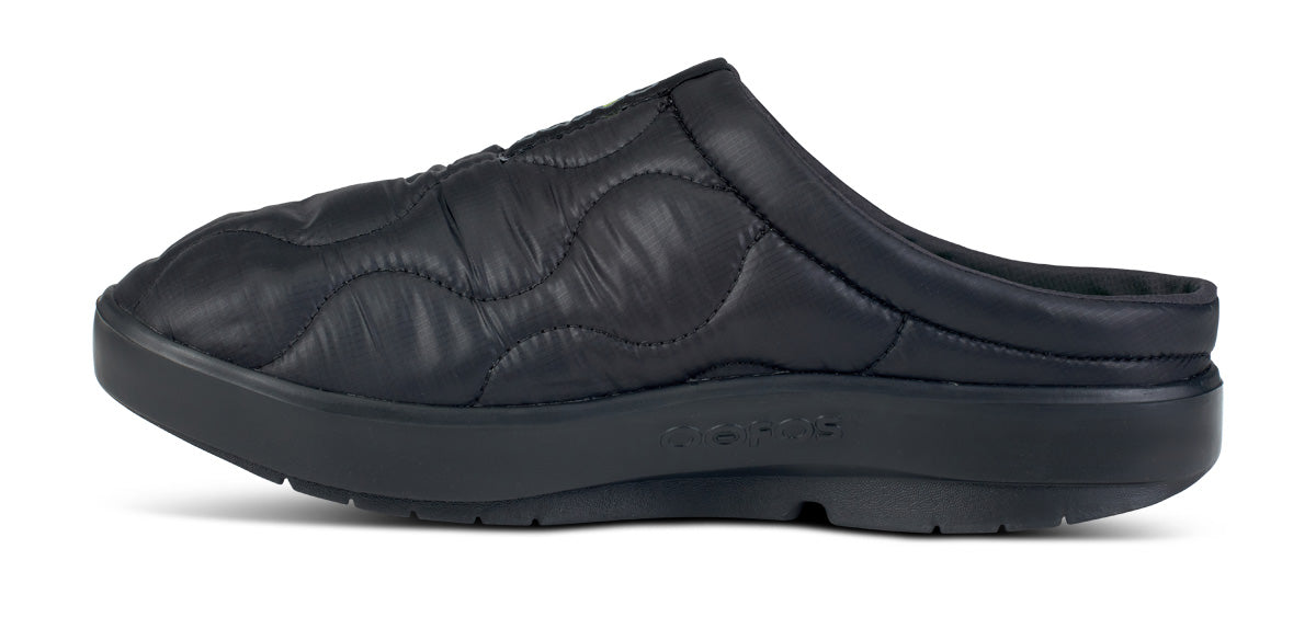 Black quilted slip-on mule with cushioned sole, side profile view