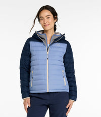 Women's quilted puffer jacket with navy sleeves, light blue body, hood, and zip pockets, front view