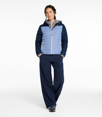 Women's hooded puffer jacket with two-tone blue colorblock design, front view on model