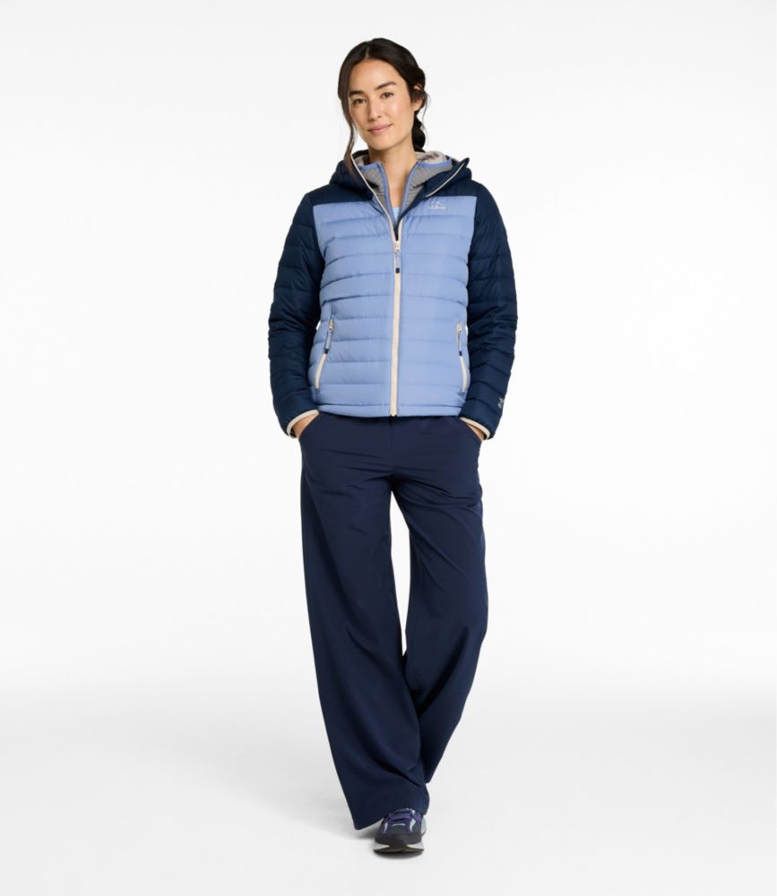 Women's hooded puffer jacket with two-tone blue colorblock design, front view on model