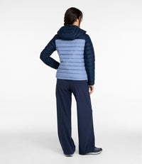 Women's hooded puffer jacket, back view, two-tone quilted design with navy sleeves and hood