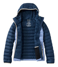 Women's hooded puffer jacket shown open, dark navy with blue side panels and cream trim