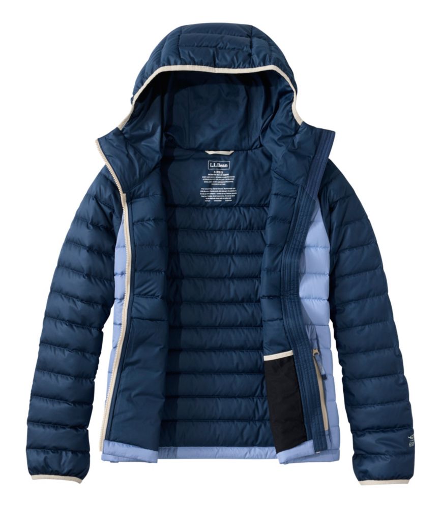 Women's hooded puffer jacket shown open, dark navy with blue side panels and cream trim