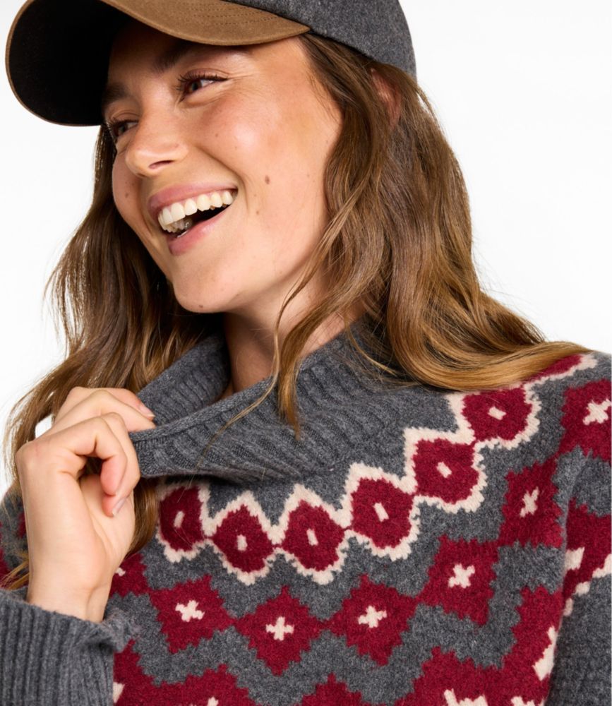Close-up detail of Fair Isle mockneck sweater with burgundy and cream geometric pattern, worn by smiling woman