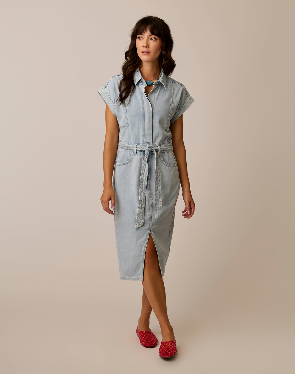 Women's light wash denim shirt dress with belt, front slit, and short sleeves, full front view
