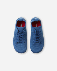 Blue knit sneakers with lace-up design and breathable mesh upper, top-down view