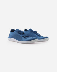 Blue knit sneakers with white soles, side view showing breathable mesh upper
