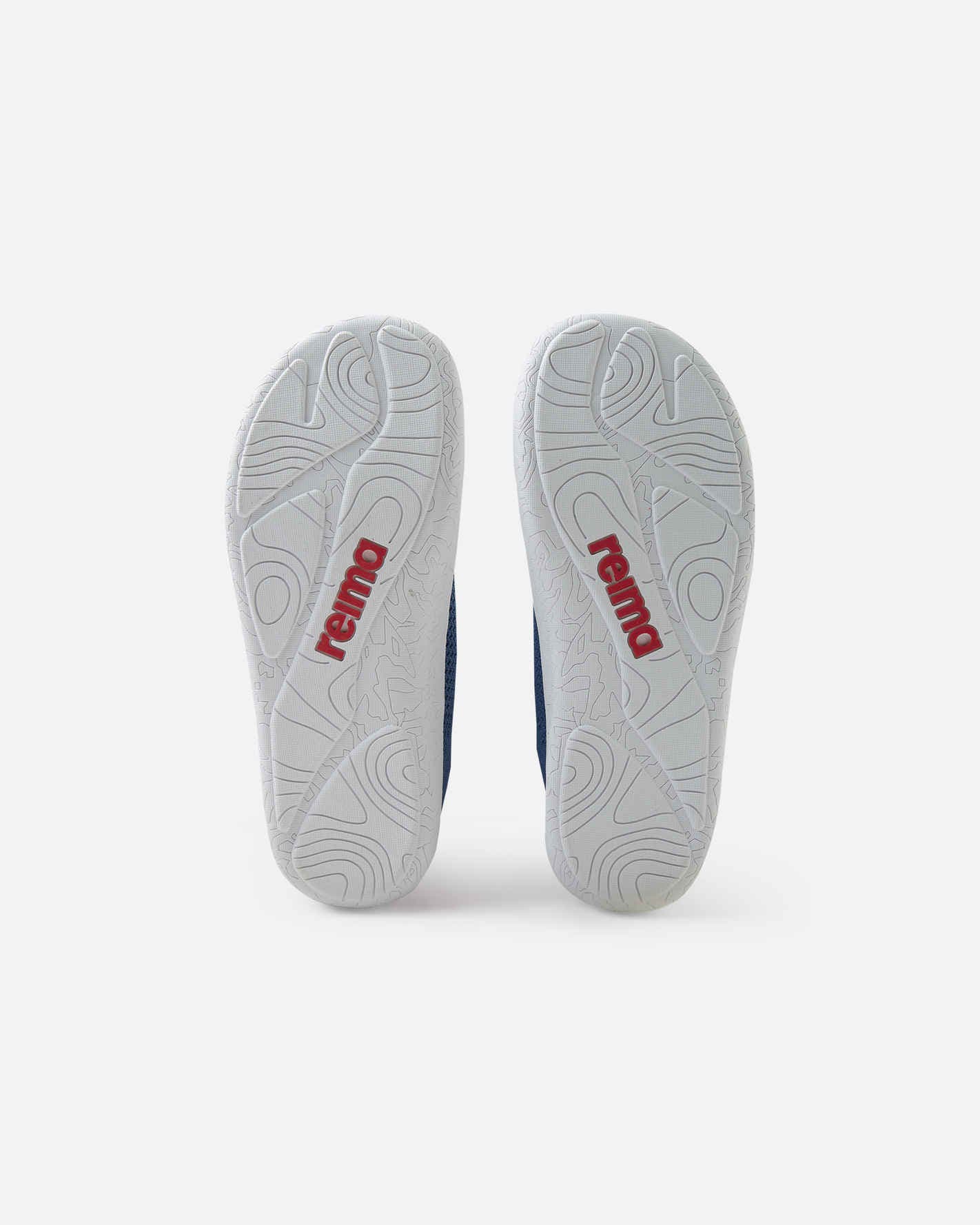 Bottom view of navy blue children's barefoot shoes showing white textured outsoles