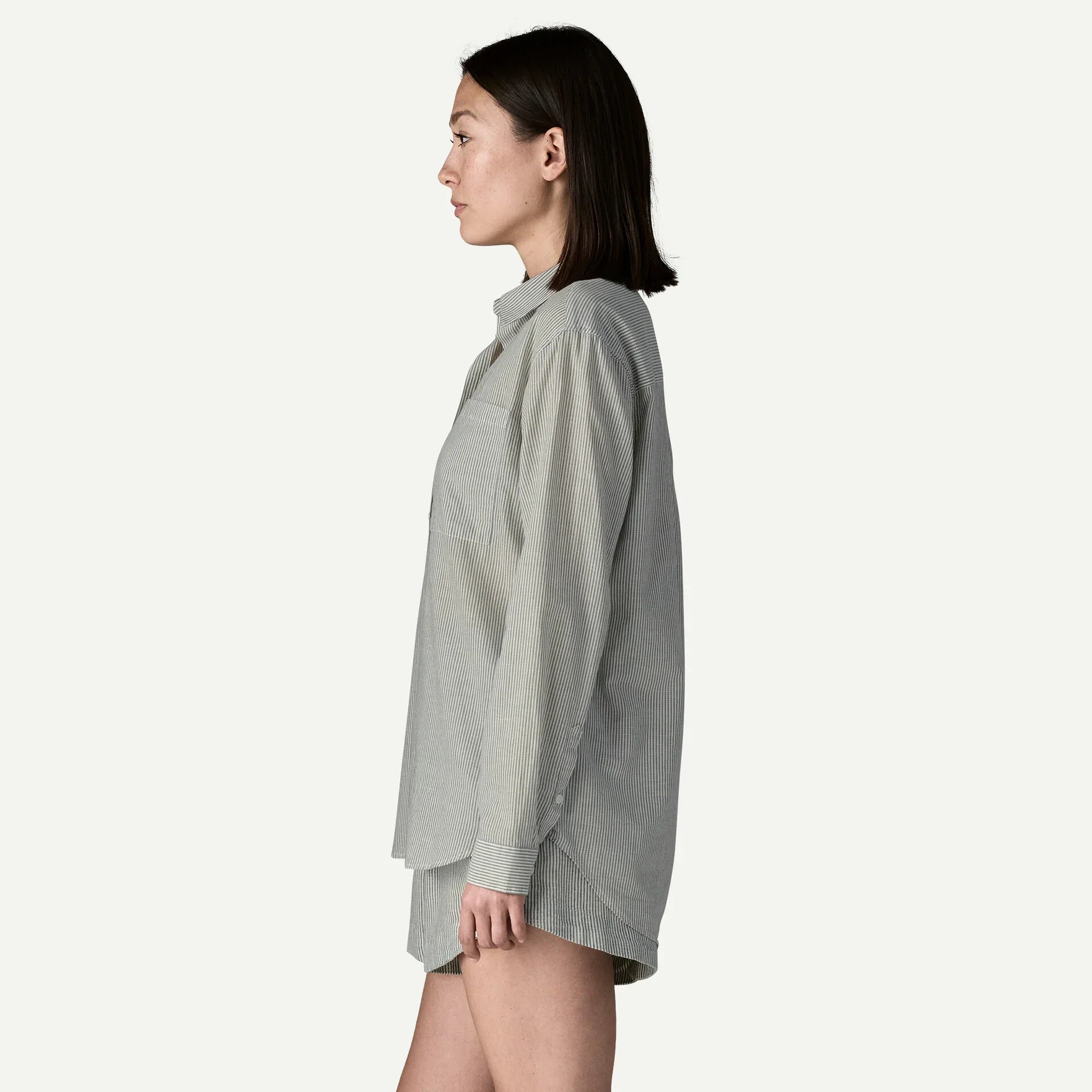 Gray striped button-down shirt shown from side profile on woman