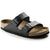 Black two-strap sandals with adjustable buckles and cork footbed, angled view