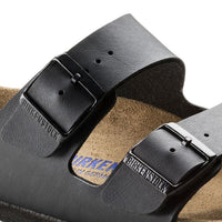 Black leather sandal with dual adjustable buckle straps and cork footbed, angled view