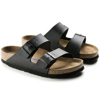Black two-strap sandals with buckles and cork footbed, angled view