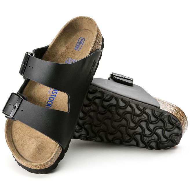 Black leather sandals with dual buckle straps and cork sole, shown with bottom sole view