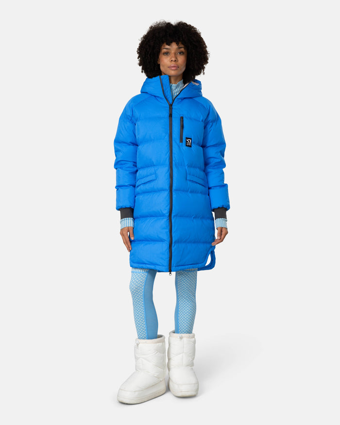 Women's long quilted puffer parka in bright blue, front view, with hood and zip closure